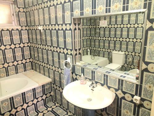 a bathroom with a sink and a mirror at La Maison dos Prazeres in Portimão