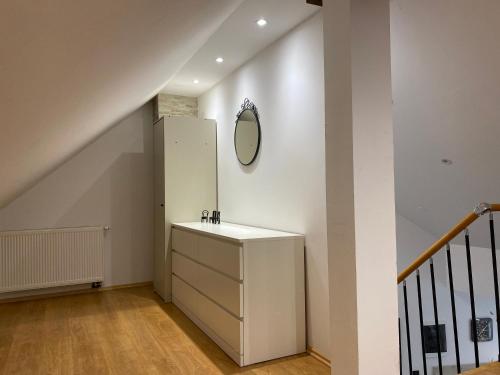 a bathroom with a sink and a mirror on the wall at APARTMAN GALERIJA in Ogulin