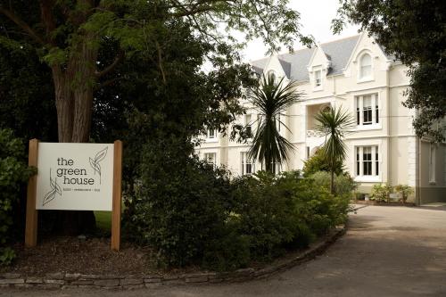 a sign in front of a white house at The Green House in Bournemouth