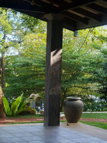 a large vase sitting under a pavilion in a park at Villa Birdlake in Hikkaduwa