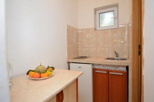 eine Küche mit einer Schale Obst auf der Theke in der Unterkunft Apartments Vladislav in Opatija