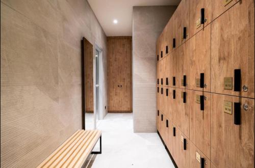 a hallway with a wooden wall with a bench at Woodside Residences Ski&Spa in Kopaonik