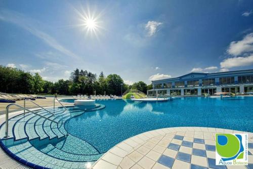 a large swimming pool in front of a building at Studio apartman Rossa in Daruvar