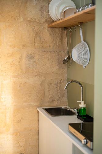a kitchen with a sink and a counter top at Terecate Experimental Relais in Melendugno