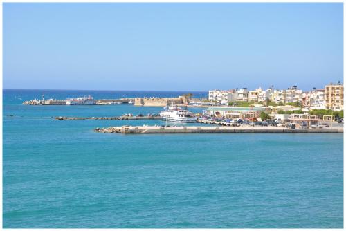 a view of a harbor with a boat in the water at Astron Hotel in Ierápetra