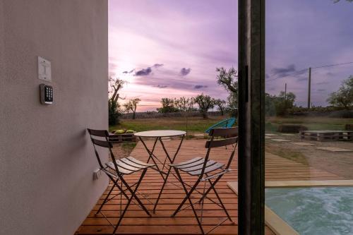 a patio with a table and chairs next to a pool at Terecate Experimental Relais in Melendugno