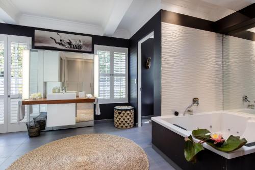 a bathroom with a tub and a sink at 14 on Klein Constantia in Cape Town