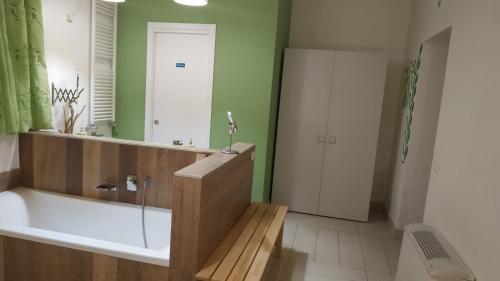 a bathroom with a bath tub and a mirror at casammare in Paola