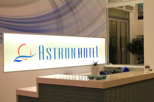 a sign for a bathroom hotel in a room at Astron Hotel in Ierápetra