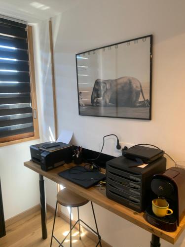 a desk with a computer and a printer on it at studio moderne in Barcelonnette