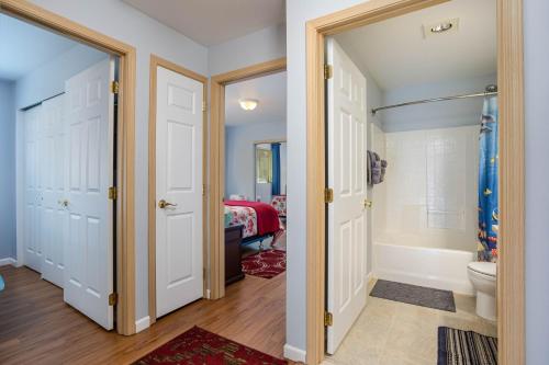 a bathroom with a shower and a toilet and a tub at Alpine Escape in Leavenworth
