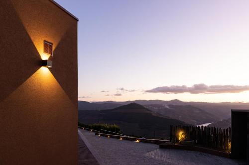 a building with a view of the mountains at Dorigem Rooms in Casal de Loivos