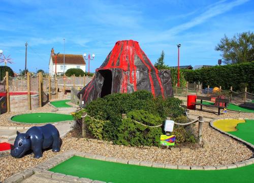 einen Spielplatz mit Rutsche in einem Park in der Unterkunft Golden Palm Resort - Palm Grove 1 - PG1 in Chapel Saint Leonards