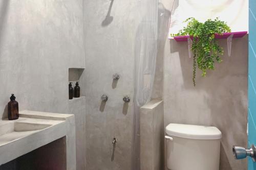 a bathroom with a toilet and a sink at Beautiful & Cozy Studio in Akumal Paradise-Wifi, AC in Akumal