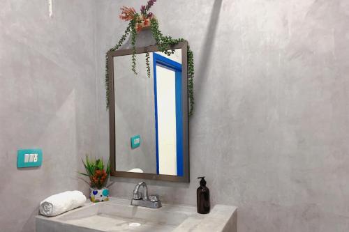 a bathroom with a sink and a mirror at Beautiful & Cozy Studio in Akumal Paradise-Wifi, AC in Akumal