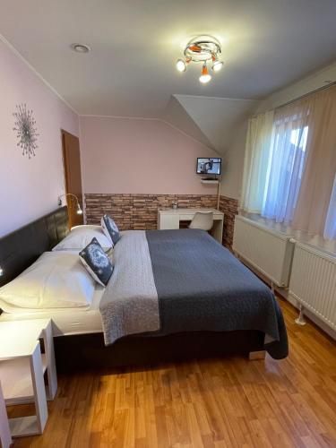 a bedroom with a large bed in a room at Penzión Pod Guglom in Mlynky 