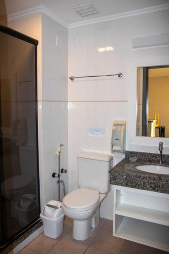 a bathroom with a toilet and a sink at Flat Summer in Florianópolis