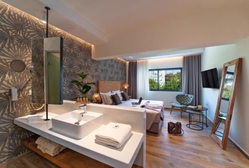 a bathroom with a sink and a living room at Naillac Boutique Hotel in Rhodes Town