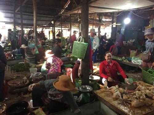 a group of people in a market with food at Homestay 1-2pax AC room 2 including private kitchen in Siem Reap