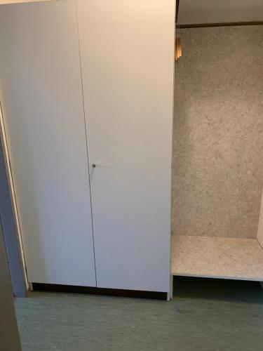 a large white cabinet in a room at Ruhige sonnige Wohnung mit Rooftopterrasse nahe Universität in Gerbrunn