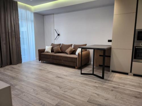 a living room with a couch and a table at OASIS-RENT in Chişinău
