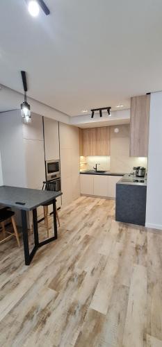 an empty room with a table and a kitchen at OASIS-RENT in Chişinău