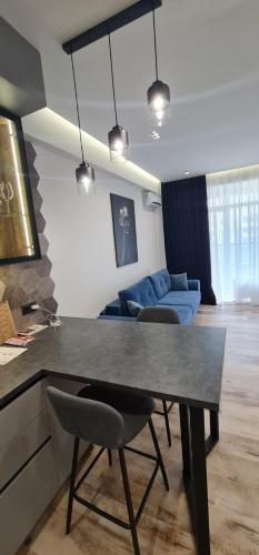 a kitchen and living room with a table and chairs at OASIS-RENT in Chişinău