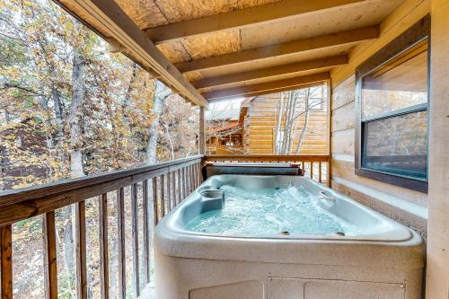 a hot tub on the balcony of a tree house at Dances with Wolves in Pigeon Forge