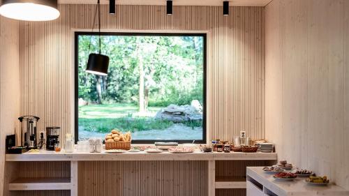 a kitchen with a counter with a window in it at Penzion Blanko in Nová Bystřice