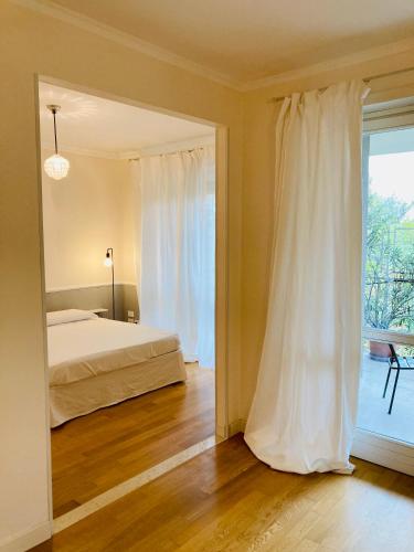 a bedroom with a bed and a large window at UN PUNTO A VERONA in Verona