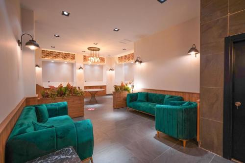 a lobby with green couches and a waiting room at Hotel Amore in Marmaris