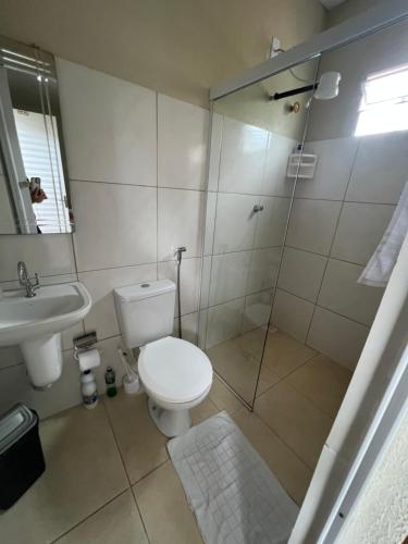 a bathroom with a shower and a toilet and a sink at Pousada da Celma in Fortaleza