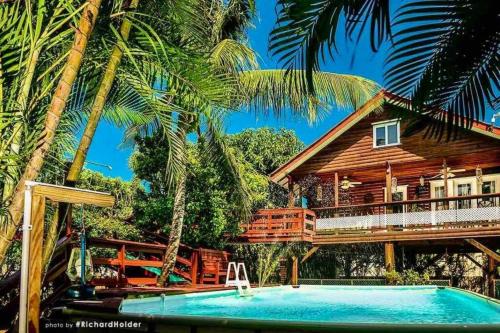 a resort with a swimming pool and a house at CentralCity “Paradise” Private Mini Resort & Pool in Belize City