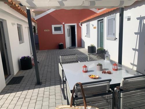 a patio with a table and chairs on a patio at Torreira Vacation Homes - Sea House in Torreira