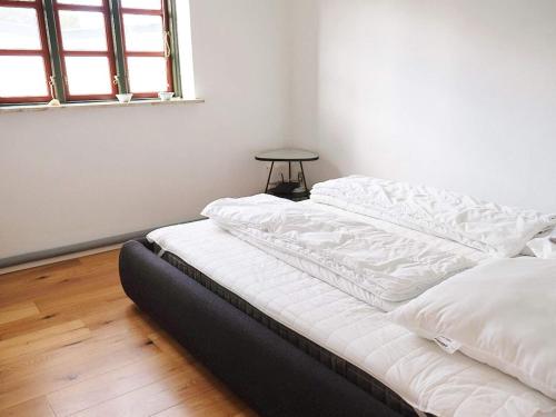an unmade bed in a room with a window at 8 person holiday home in Vesløs-By Traum in Vesløs