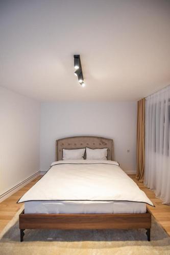 a bedroom with a large bed with white sheets at Moonlight Hill Point in Deal