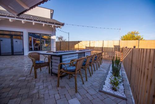 a patio with a table and chairs and a fence at Moonlight Hill Point in Deal