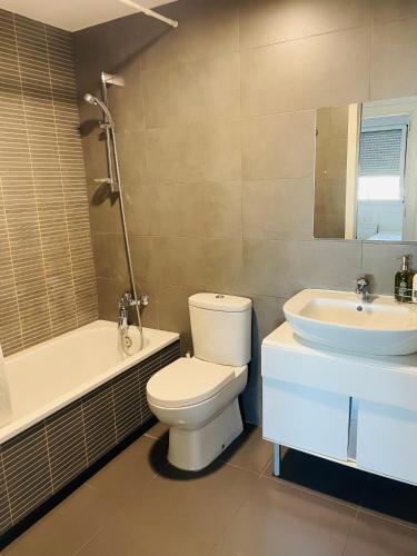 a bathroom with a toilet and a sink at Fira de Barcelona City View Apartment with Garage Parking in Hospitalet de Llobregat