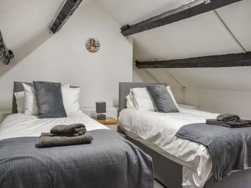 a bedroom with two beds with towels on them at Llwyn Yr Arth in Llanbabo