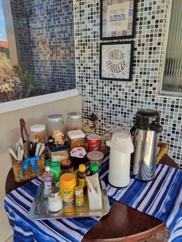 a table topped with a blue and white striped table cloth at Aloha Beach Guest House in Maragogi