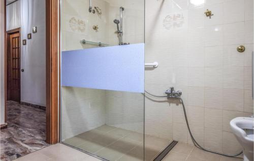 a shower with a glass door in a bathroom at Beautiful Apartment In Reggio Calabria With Wifi And 3 Bedrooms in Reggio di Calabria