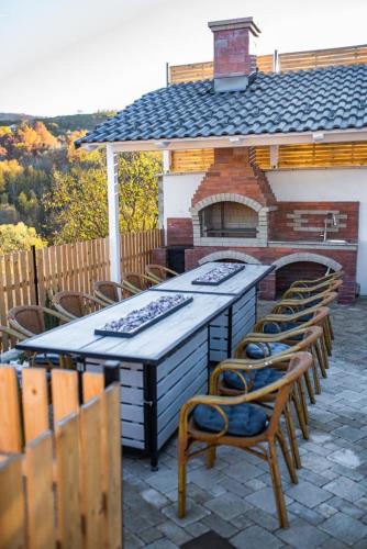 a patio with a grill with chairs and a table at Moonlight Hill Point in Deal