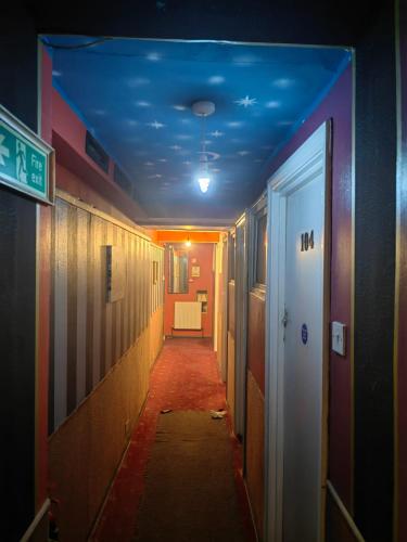 a hallway with a blue ceiling in an office building at City View Hotel Roman Road in London
