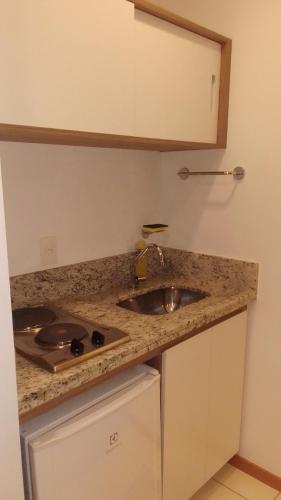 a kitchen with a sink and a counter top at Flat Constelações in Campos dos Goytacazes