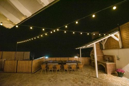 a patio with a table and chairs and lights at Moonlight Hill Point in Deal