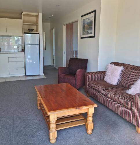 a living room with a couch and a coffee table at Methven Motel & Apartments in Methven