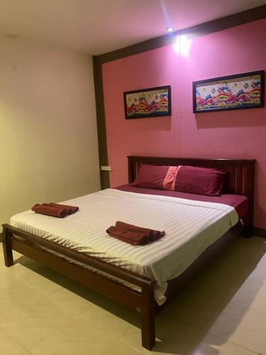 a bedroom with a bed with two towels on it at Pak Klong Room for rent in Phi Phi Don