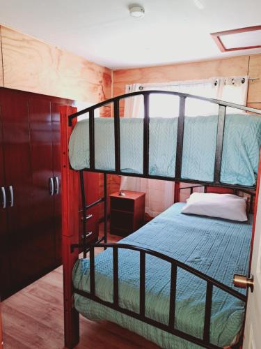 a bedroom with two bunk beds in a room at Cabañas Tripanko Chiloe in Ancud