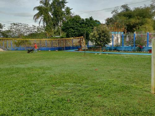 a person and a dog in a field with a soccer ball at Hotel campestre la Maria in Villavicencio