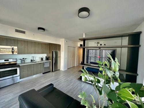a large kitchen with a black couch in a living room at Beautiful downtown ocean view. in Miami